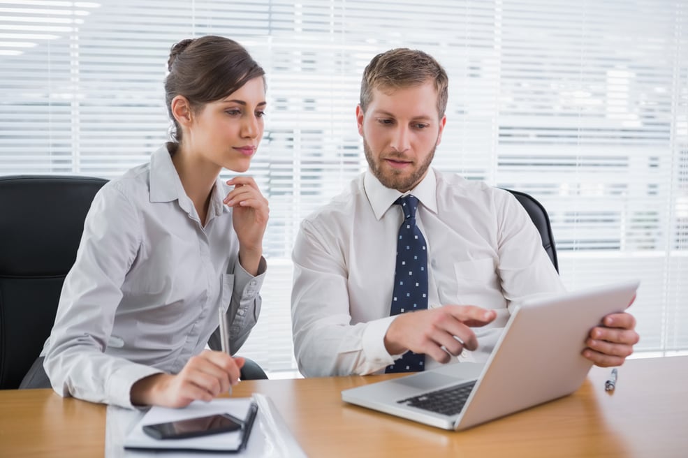 Business people working together on laptop in office at desk-2
